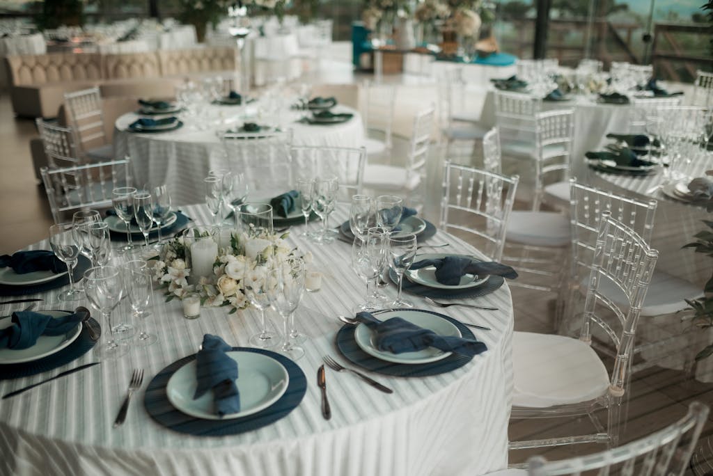 Beautifully arranged tables with elegant decor at an indoor wedding reception.